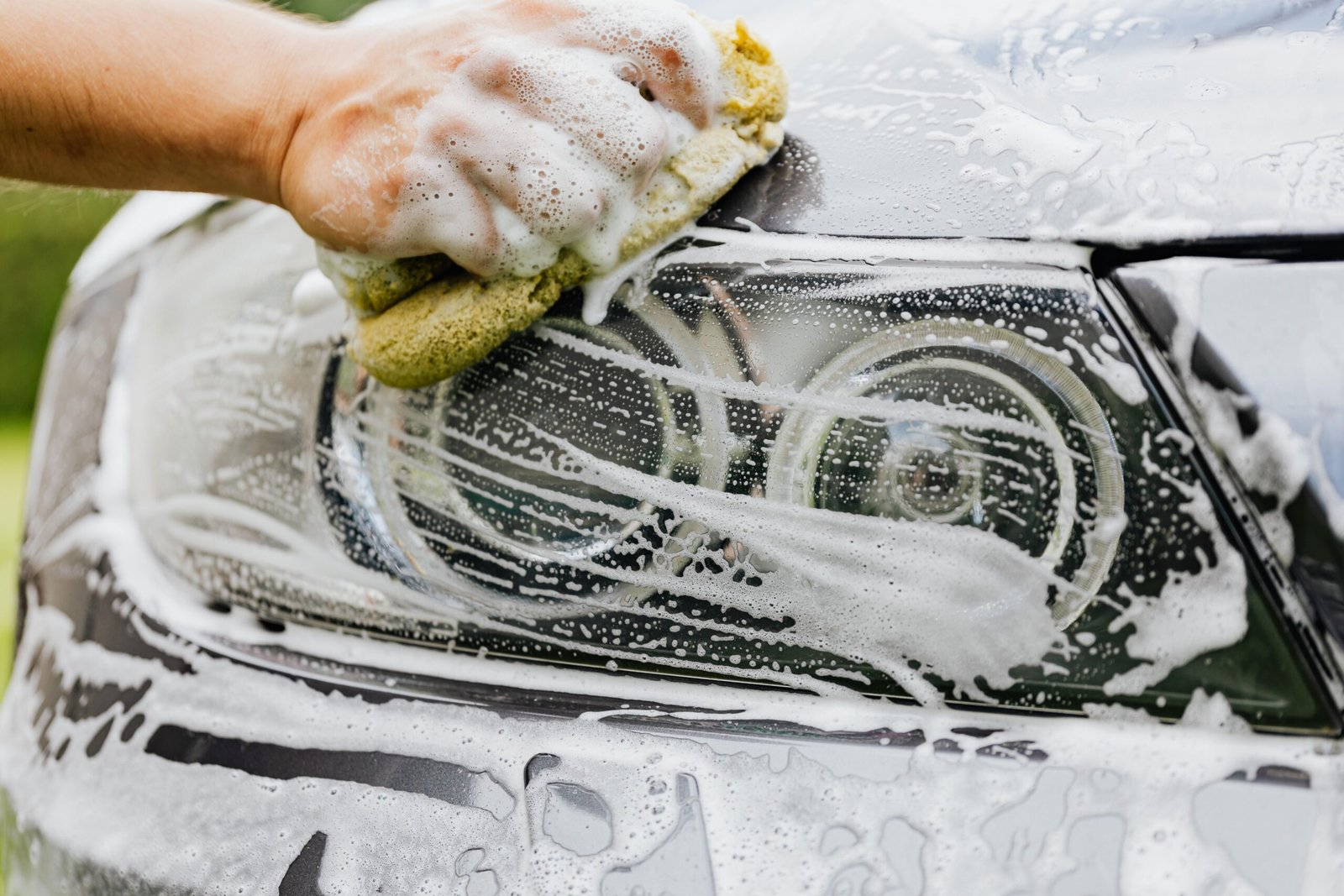 Car exterior being washed in detail
